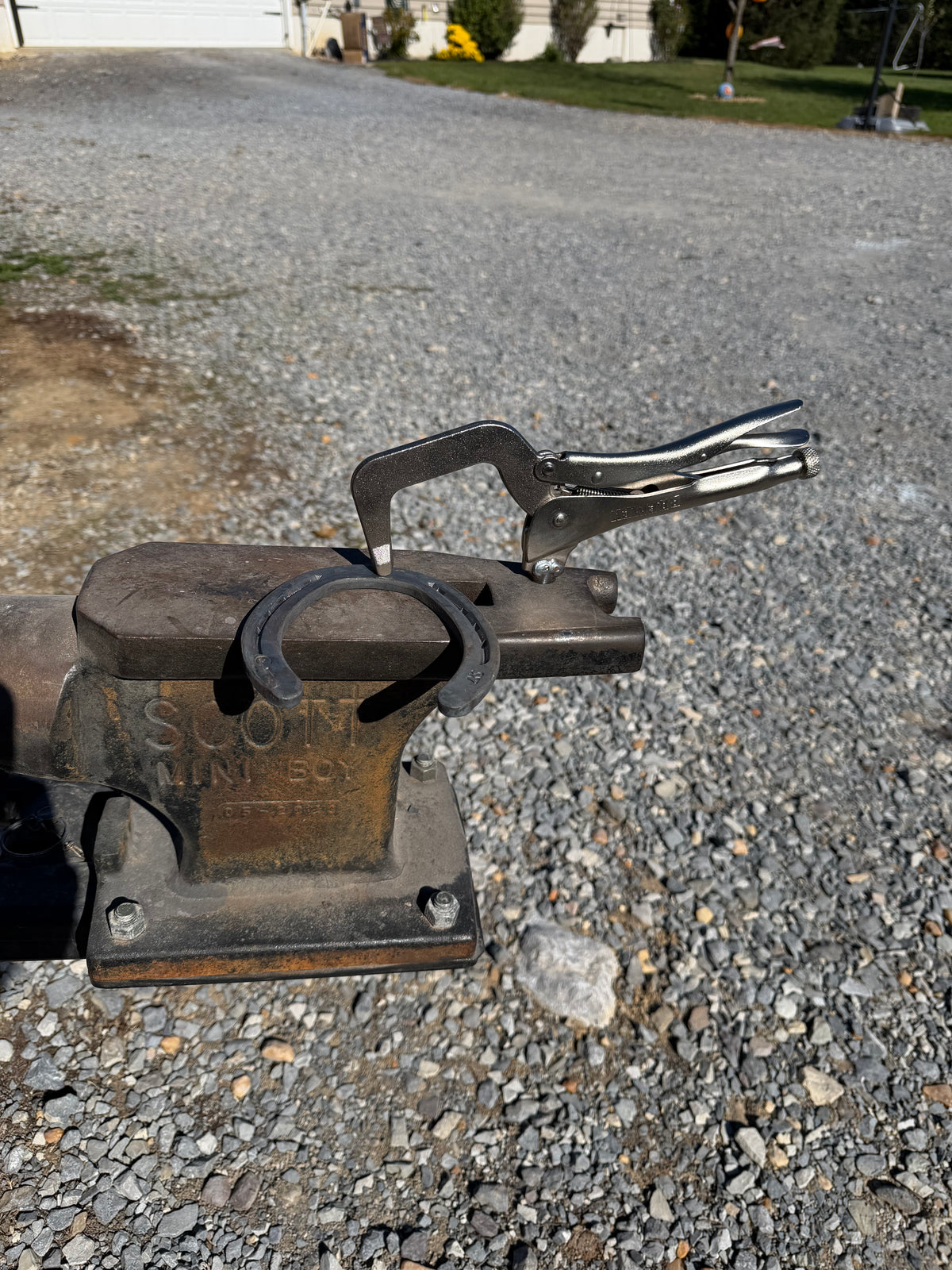 Adjustable anvil hold down